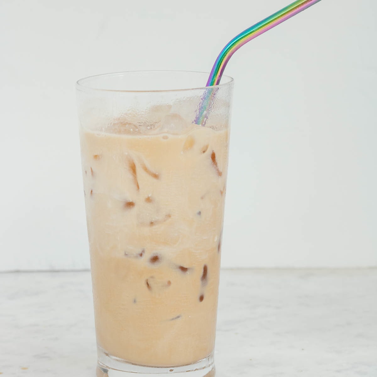 Iced coffee drink on glass jar with featuring coffee, milk, and ice
