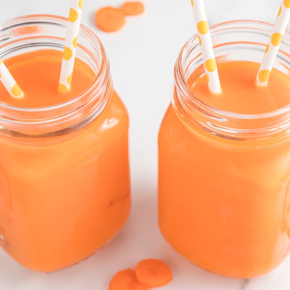 Juice In Glass Jar And Orange On Kitchen Table. Stock Photo